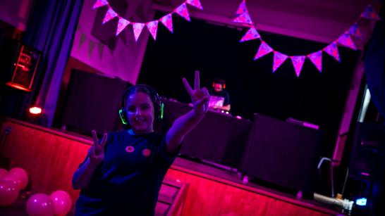 meisje maakt een peace teken tijdens een silent disco in de Wollewei
