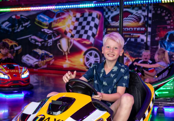Jongen zit in botsauto